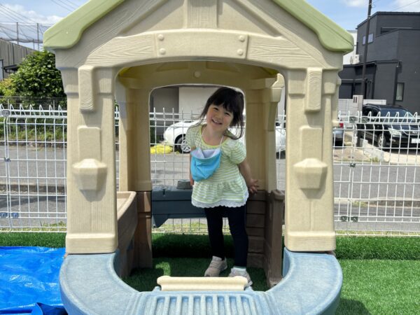 A child in the playhouse at Nagoya international school playground